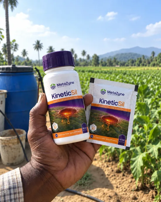 Farmer holding a KineticSil bottle and 10 ml sachet in front of a tea-garden field, hills in the background