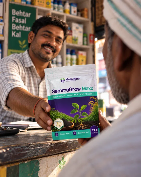 A shopkeeper handing a pouch of SemmaGrow Maxx across the counter to a farmer