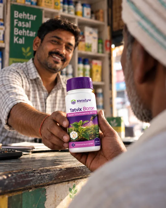 A shopkeeper handing a bottle of Tatvix Boron across the counter to a farmer